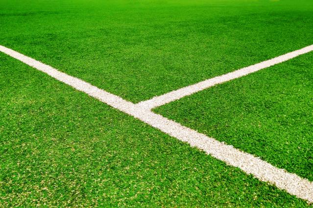 green football field with white lines