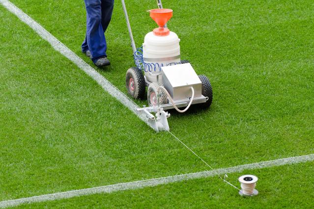 painting white lines on the field